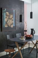 Contemporary dining room with black painted feature wall 
