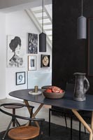 Contemporary dining room with black painted feature wall 