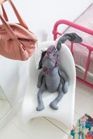 Toy rabbit on modern chair in childrens bedroom 