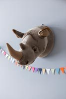 Soft toy trophy head of a rhino on wall 