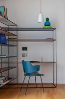 Modern home office in corner with built-in shelving and desk unit 