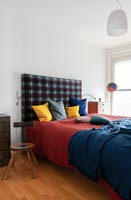 Patterned upholstered headboard in modern bedroom 