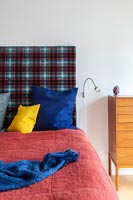 Patterned upholstered headboard in modern bedroom 