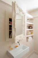 Decorative mirrored cabinet above bathroom sink 