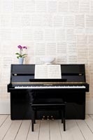 Piano with wall of sheet music 