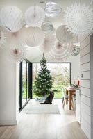 Display of white paper lanterns hanging from ceiling at Christmas 