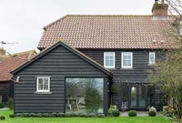 Exterior of black wooden country house 