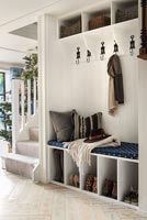 Modern country hallway with built-in seat, coat and shoe storage