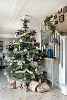 Large Christmas tree in modern country hallway 