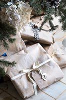 Detail of wrapped Christmas presents under tree 
