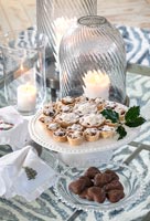 Mince pies on cake stand with candles 