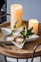 Mince pies and candles on side table 