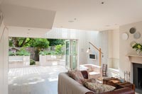 Contemporary living room with view to courtyard garden through bifold doors 