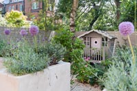 Decorative painted wooden playhouse in modern courtyard garden