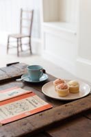 Tea and cakes on wooden box coffee table 