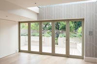 Contemporary bifold doors with view to courtyard garden 