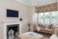 Modern living room with wall mounted television set within picture frame 