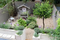 Painted wooden playhouse in courtyard garden - overhead view 