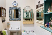 Small bathroom with mirrors on every wall 