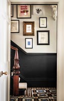 Display of framed pictures on hallway wall 