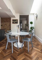 Parquet flooring and modern furniture in dining room 