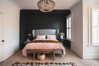 Modern bedroom with black painted feature wall 