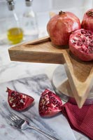 Pomegranates on wooden tray