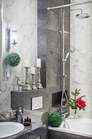 Green and red Christmas decorations in modern bathroom 