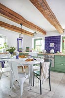 Green and white country kitchen diner 