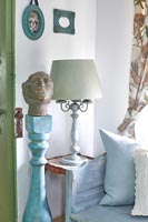 Lamp on side table in country cottage 