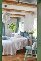 Country bedroom with blue and green accessories 