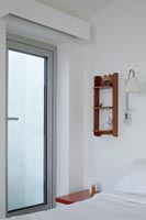 Glass internal door in modern white bedroom 