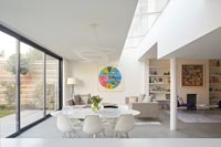 White dining table and chairs in modern open plan living space 