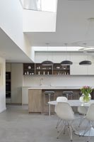 White circular dining table and chairs in modern kitchen-diner 