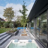 Jacuzzi and seating area on modern terrace 