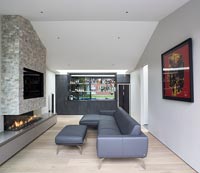 Contemporary fireplace  in living room with bar at one end 