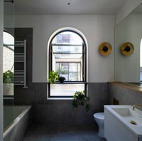 Arched window in modern bathroom 