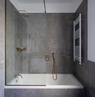 Grey and white modern bathroom with gold taps 