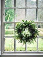 Traditional window with Christmas wreath 