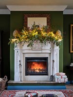 Lit fire place with Christmas garland