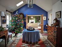 Blue painted hallway with central table and Christmas tree 