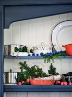 Country kitchen shelves decorated for Christmas 