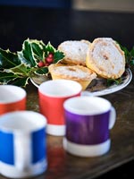 Colourful coffee cups and mince pies 