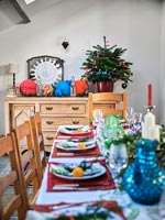 Dining table decorated for Christmas in country dining room 