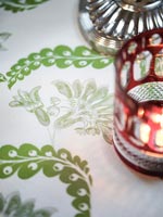 Detail of tealight candle in decorative red glass