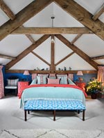 Country bedroom with vaulted ceiling and Christmas decorations 