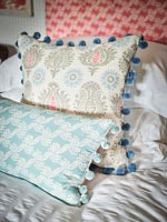 Patterned cushions on bed - detail 