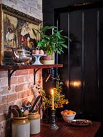 Country kitchen corner with lit candle at Christmas time 