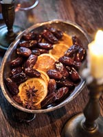 Dates and orange slices on silver plate - dining table detail at Christmas 