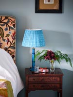 Blue lamp on bedside table